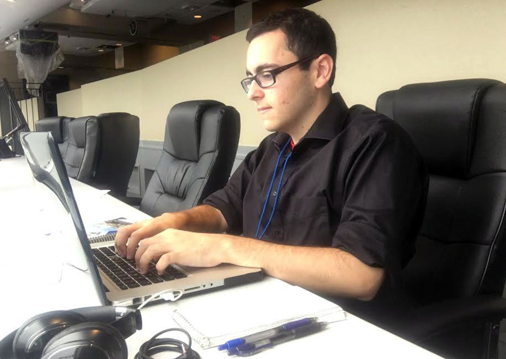 Reporter with laptop covering game