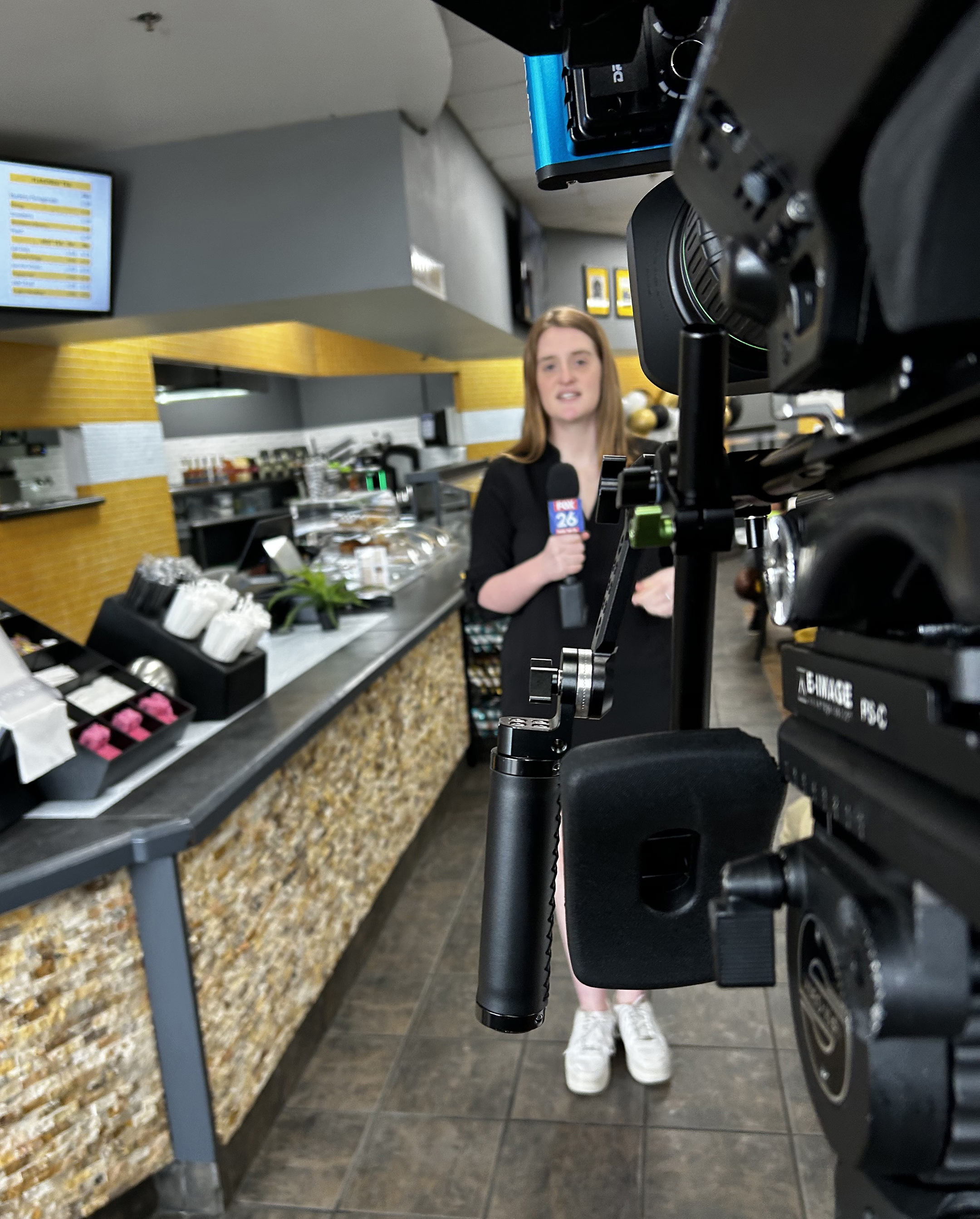 Abby Lord stands in front of a television camera. 