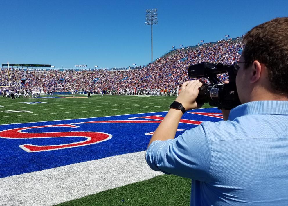 Student filming KU football game