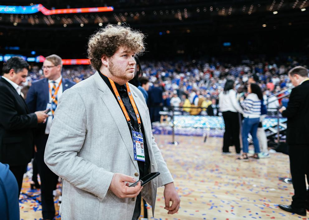 Nathan Swaffar on the court filled with confetti after the Jayhawks won the national title in April 2022.