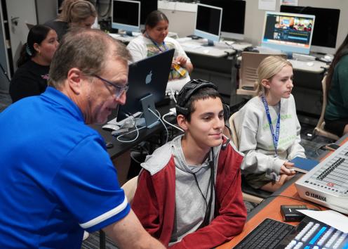 Students operating graphics and teleprompter.