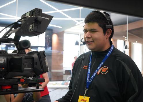 student behind the camera
